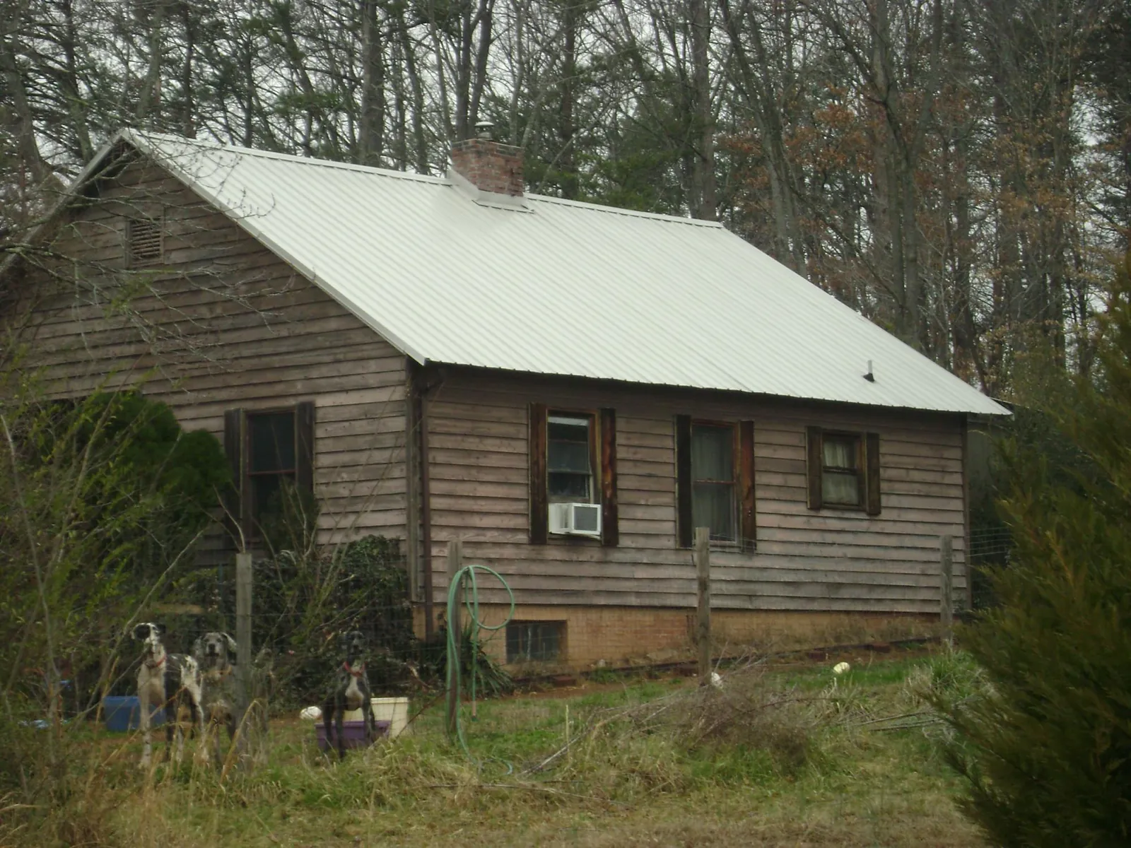 White metal roof on an old wood sided farmhouse, from a Metal Roof Installation job in Glen